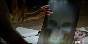 Karen holds an x-ray similar to The Punisher's signature look.