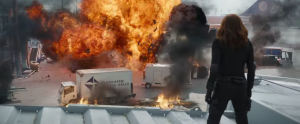 Black Widow looks at an explosion